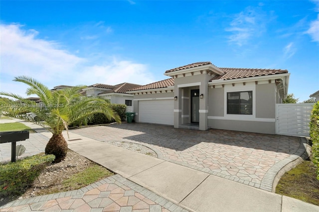 mediterranean / spanish-style house with a garage