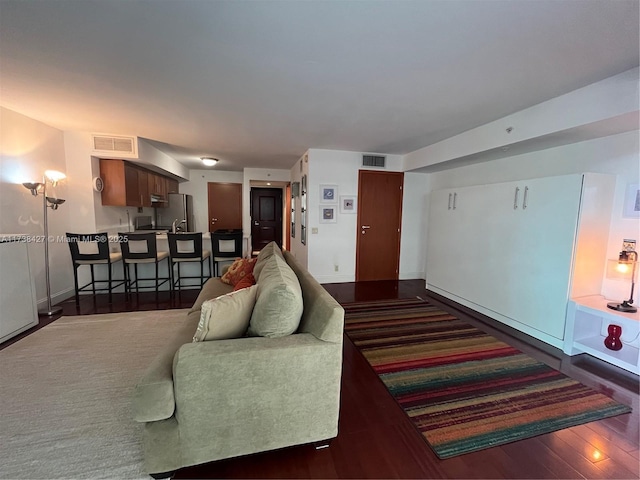 living room featuring dark wood-type flooring