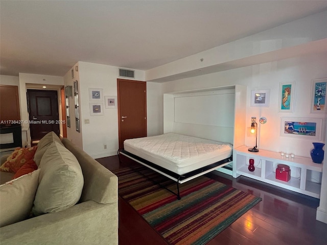 bedroom featuring dark hardwood / wood-style flooring