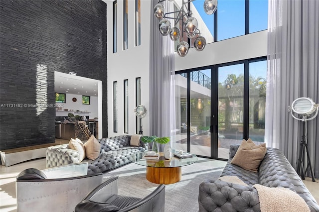 living room featuring a high ceiling and an inviting chandelier