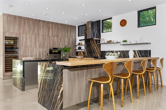 bar with wall chimney range hood and oven