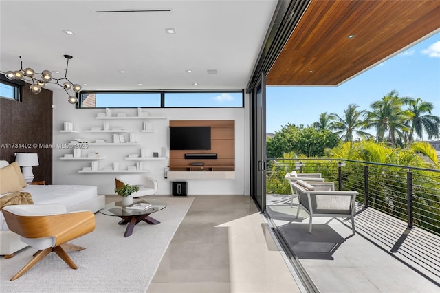 living room featuring a wall of windows and a chandelier