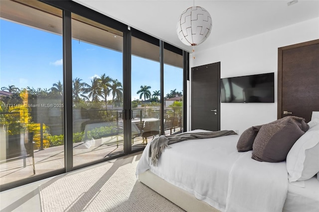 bedroom with floor to ceiling windows and access to outside