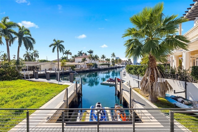 dock area featuring a water view and a yard