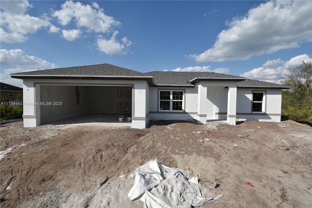 view of front of house featuring a garage, roof with shingles, and stucco siding