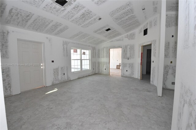 kitchen featuring lofted ceiling, sink, white cabinetry, stainless steel appliances, and light stone counters