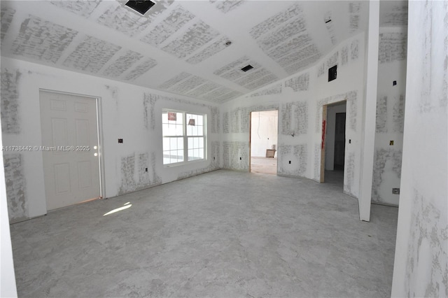 unfurnished room featuring lofted ceiling