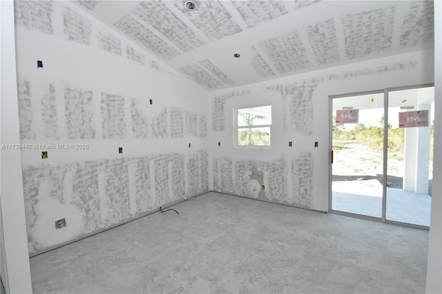 unfurnished room featuring vaulted ceiling