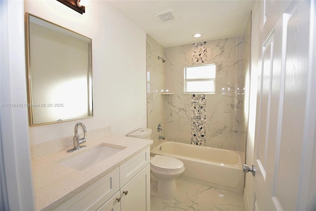 full bathroom with tiled shower / bath, vanity, and toilet