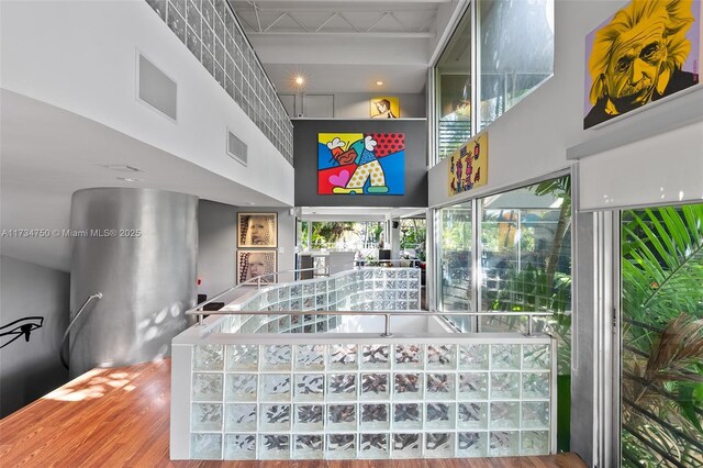 interior space featuring a high ceiling and wood-type flooring