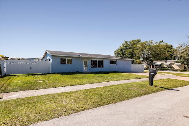 ranch-style house featuring a front lawn