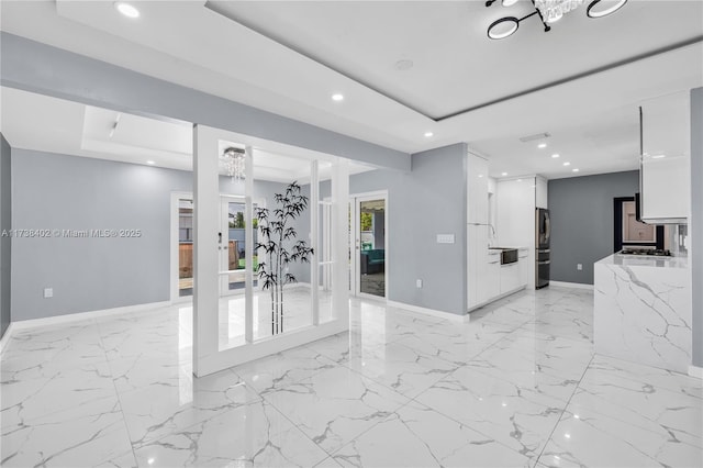 unfurnished room with french doors and a tray ceiling