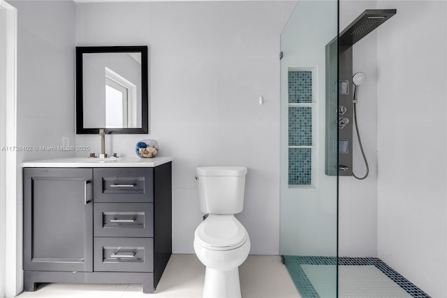 bathroom featuring vanity, toilet, and a shower