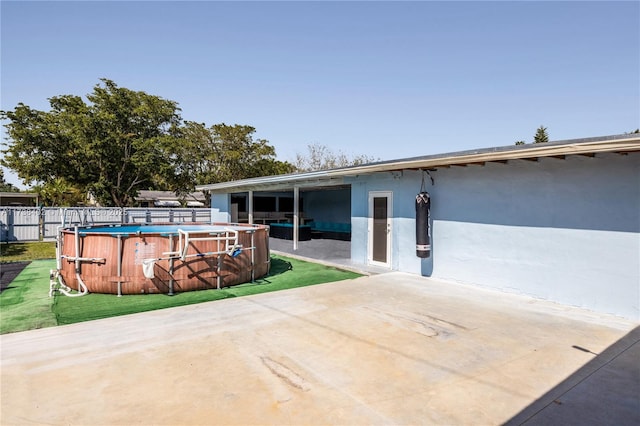 view of patio with a fenced in pool