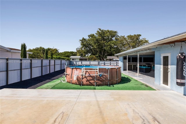 view of patio featuring a fenced in pool