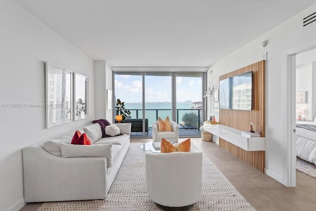 living room with a water view and expansive windows