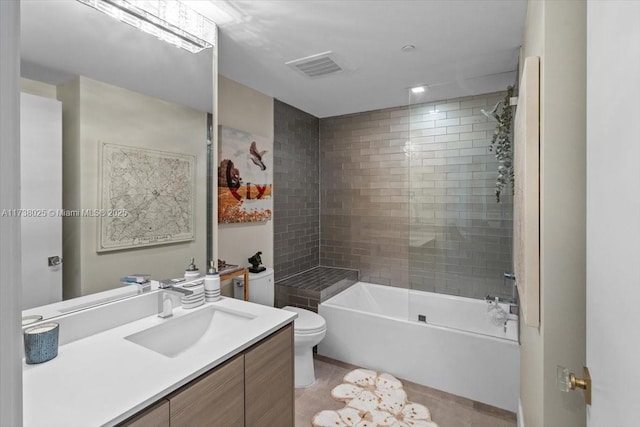 full bathroom featuring vanity, toilet, and tiled shower / bath combo