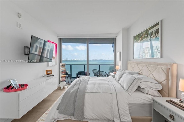 bedroom with expansive windows and access to outside