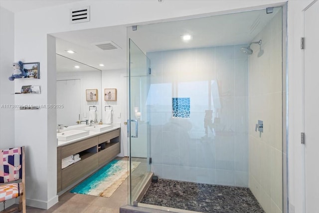 bathroom featuring vanity and a shower with shower door