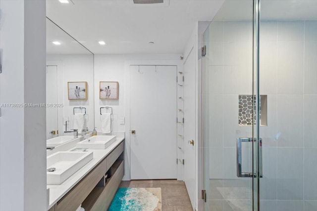 bathroom featuring tile patterned floors, vanity, and a shower with door