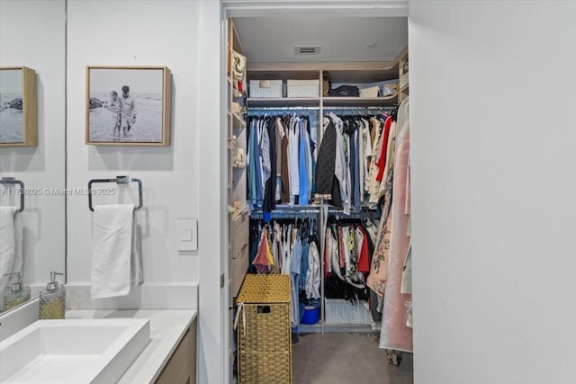 bathroom with vanity and concrete flooring