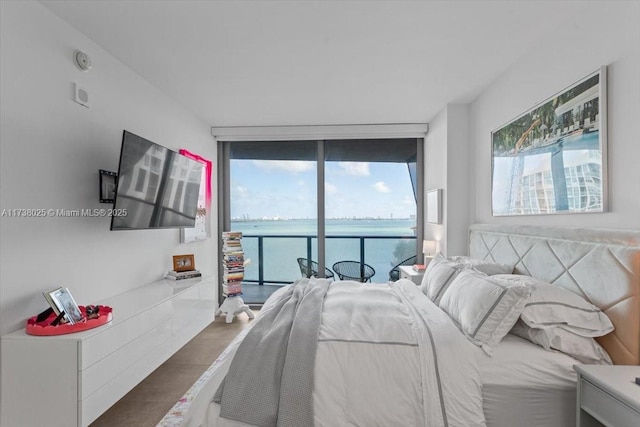 bedroom with dark hardwood / wood-style flooring, access to exterior, and floor to ceiling windows