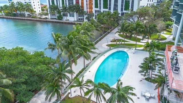 view of pool with a patio area and a water view