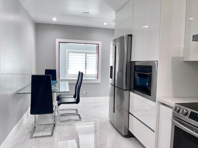 kitchen with white cabinets and appliances with stainless steel finishes