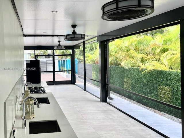 unfurnished sunroom featuring sink