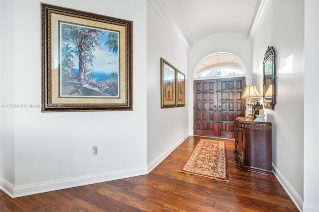 hallway featuring wood-type flooring, vaulted ceiling, and ornamental molding