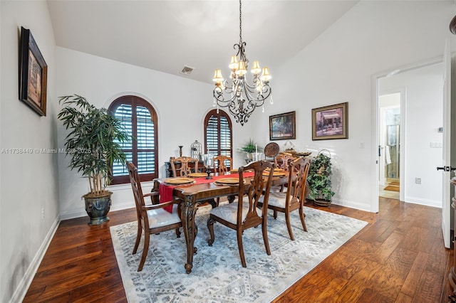 dining area featuring lofted ceiling and dark hardwood / wood-style flooring