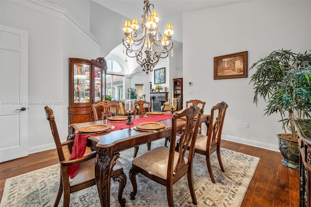 dining space with an inviting chandelier and dark hardwood / wood-style flooring