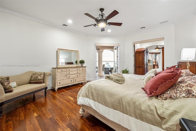 bedroom featuring ornate columns, ornamental molding, dark wood-type flooring, and ceiling fan