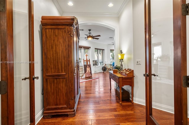 corridor featuring ornamental molding, dark hardwood / wood-style floors, and french doors