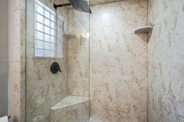 bathroom with a healthy amount of sunlight and tiled shower