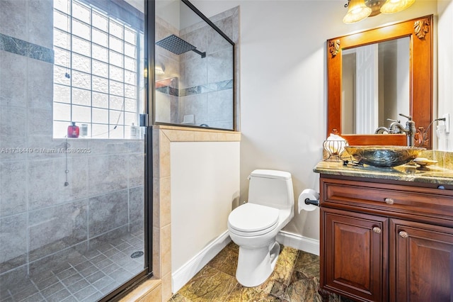 bathroom featuring vanity, toilet, and a shower with shower door