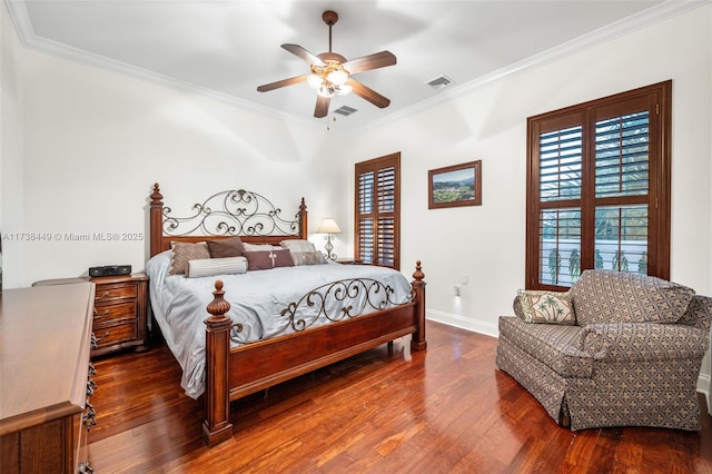 bedroom with ornamental molding, dark hardwood / wood-style floors, and ceiling fan