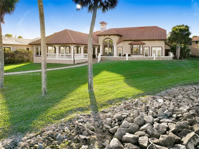 back of house with a lawn