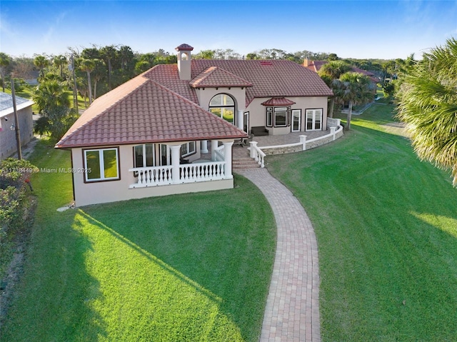rear view of property featuring a gazebo and a lawn