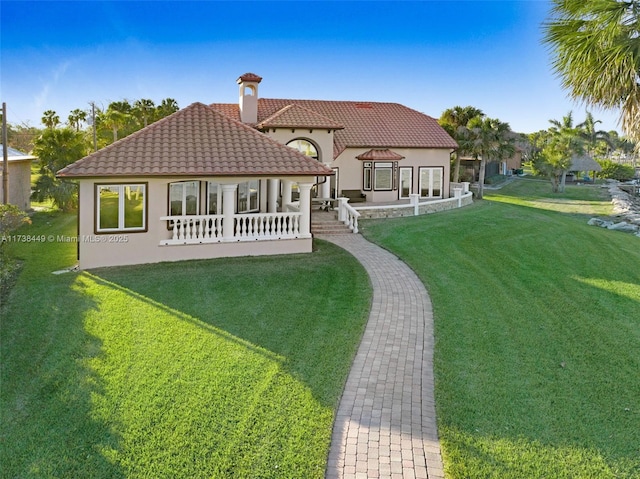rear view of property with a yard