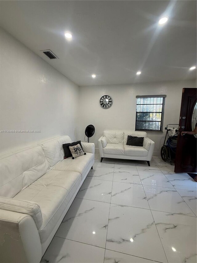 living room with recessed lighting, visible vents, and marble finish floor