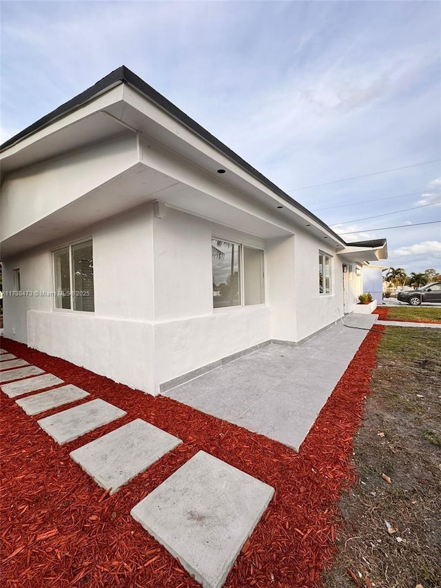 view of property exterior with a patio area