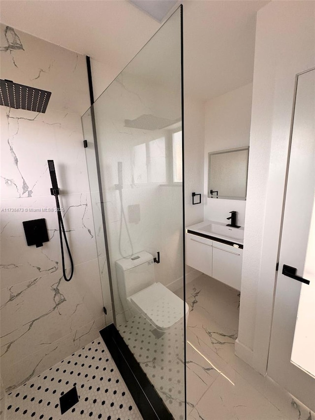 bathroom with tiled shower and vanity