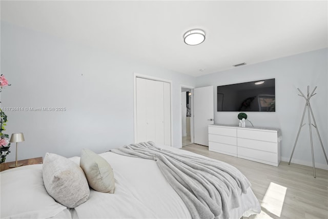 1410 S 22nd Ave, Hollywood, FL 33020 - bedroom with light wood finished floors, a closet, and baseboards