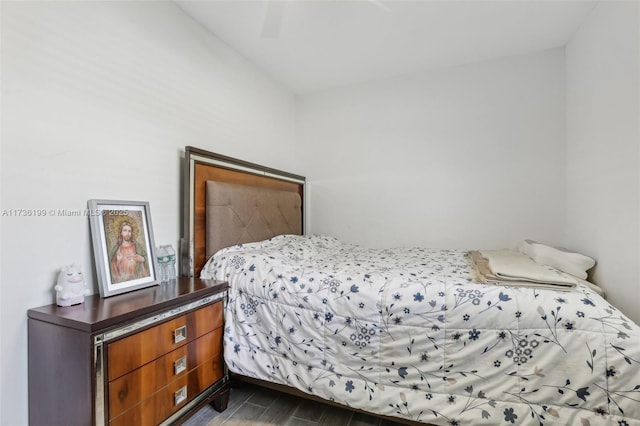 bedroom with dark wood-type flooring and ceiling fan