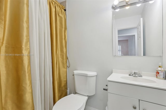 bathroom with vanity, walk in shower, and toilet