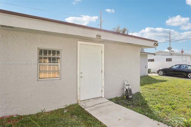 property entrance with a yard