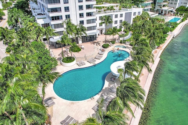 view of swimming pool with a water view and a patio area