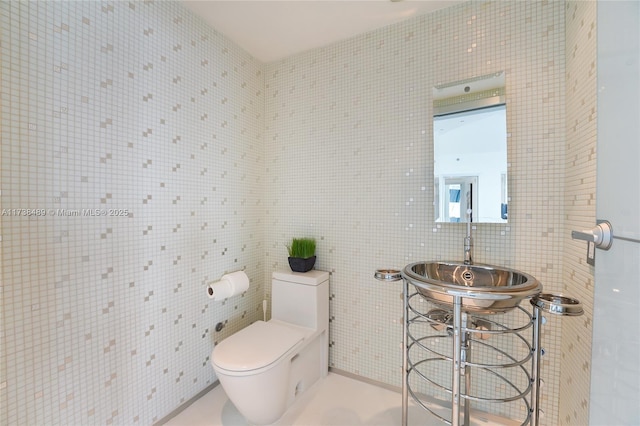 450 Alton Rd Unit 3401, Miami Beach, FL 33139 - bathroom featuring toilet, tile walls, and a sink
