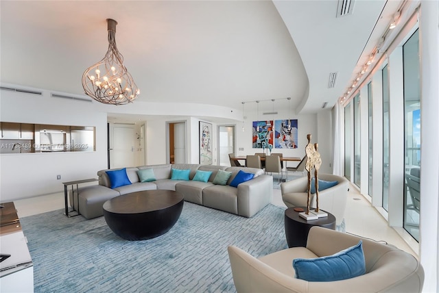 living room with track lighting and a chandelier